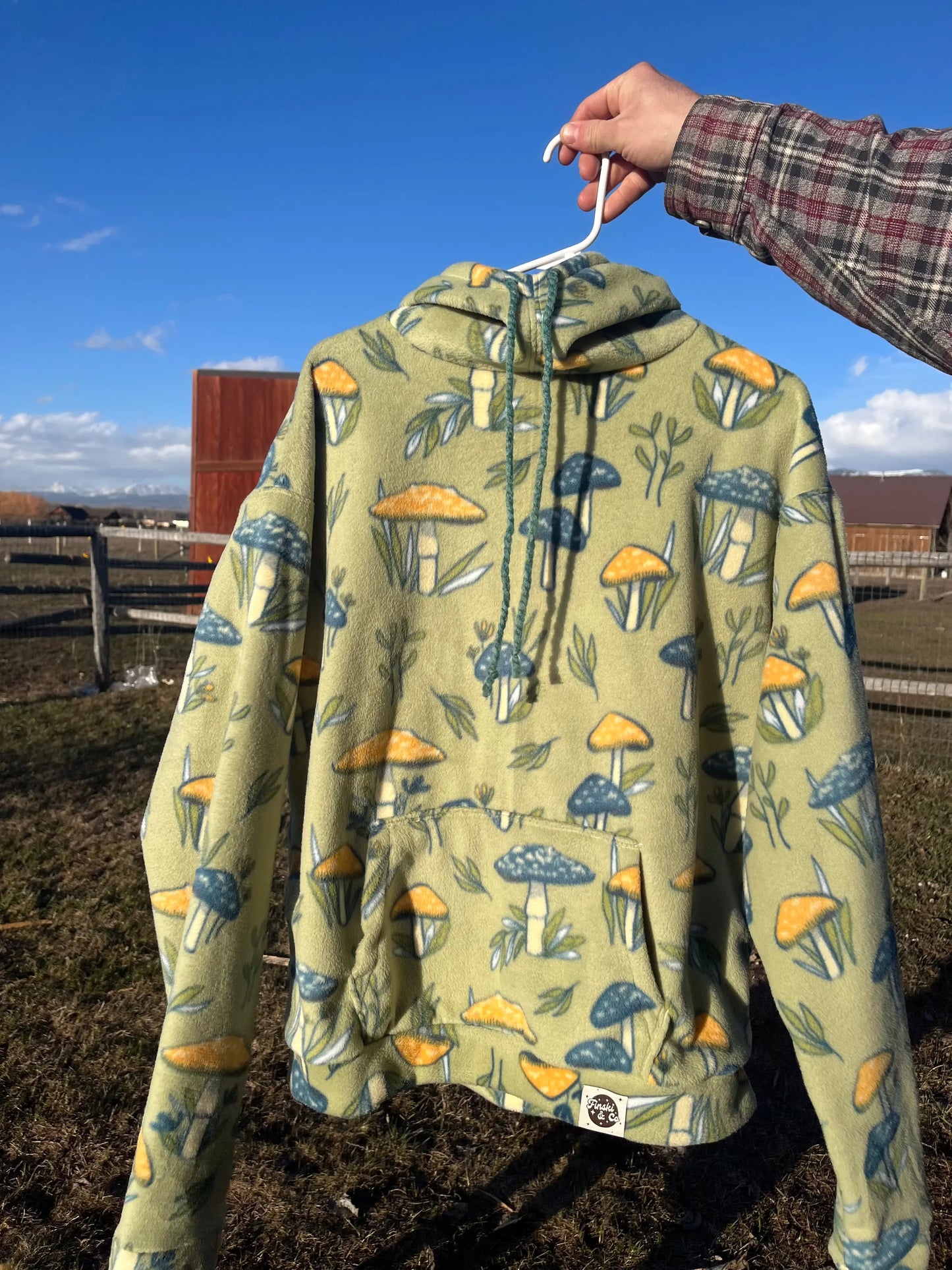 Handmade fleece hoodie, green base with blue and yellow mushrooms. Cozy hooded pullover for skiing, camping, river trips, concerts,